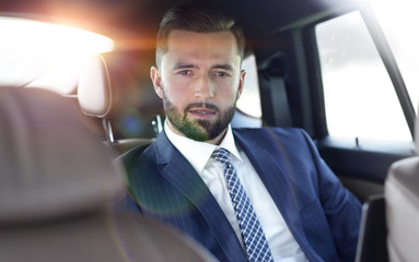 Close-up of a successful businessman sitting in a car