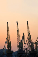 Fototapeta premium Port cargo crane at sunset