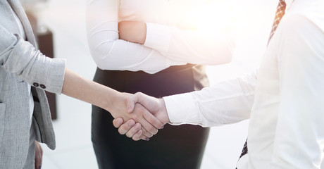 handshake business partners in the office.