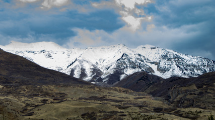 Fototapeta na wymiar Snow-covered Rocky Mountains with a dramatic sky