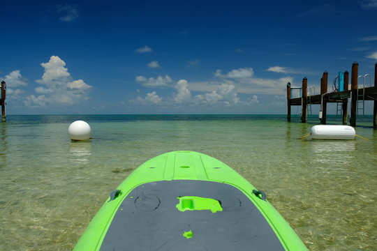 Lime green paddle board ready to head out into open waters off the Florida Keys