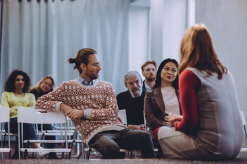 Counseling session. Psychologist talking to patients. Addicted people having good time together on special group therapy. Toned concept.