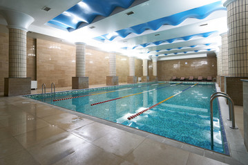 Indoor public swimming pool interior in fitness gym club. healthy concept