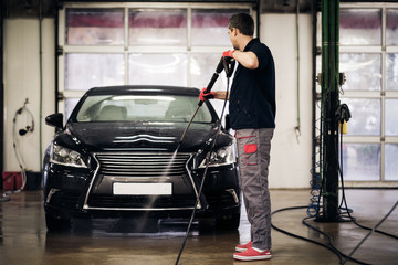 Fototapeta na wymiar Man working on a car wash.