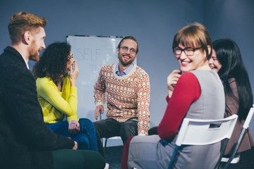 Adults sitting in tight circle and smiling after deep session. Support concept. Toned .