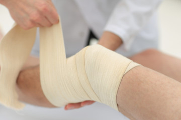 closeup. doctor bandaging a patient's leg
