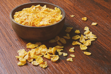 Top view of bowl full of cereals on wooden background