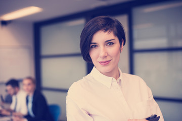 hispanic businesswoman with tablet at meeting room