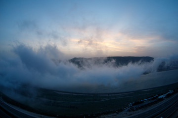 Beautiful clouds flying over the lake near mountains. Evening time shot over the clouds. Baku, Azerbaijan