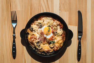 tortilla con potatos. Typical spanish dish with bacon cheese tomato sauce and egg