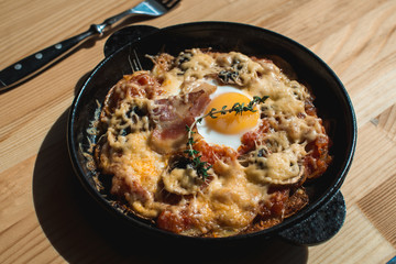 tortilla con potatos. Typical spanish dish with bacon cheese tomato sauce and egg