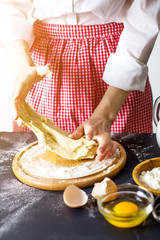 Making dough by female hands at bakery