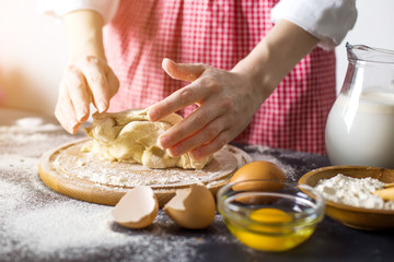 Making dough by female hands at bakery