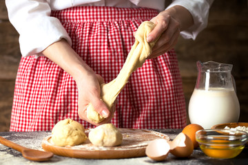 Making dough by female hands at bakery