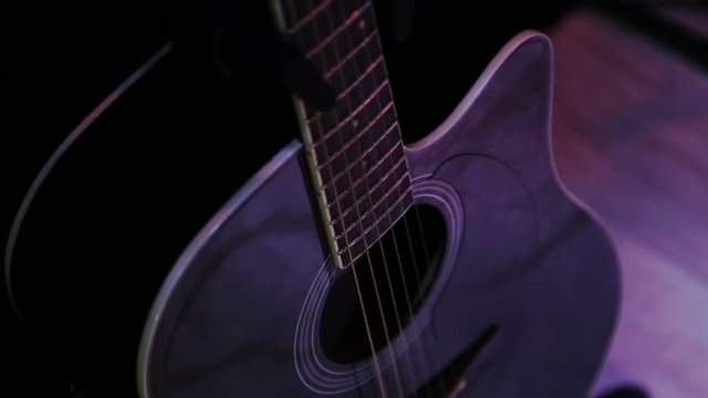 The man pulls out a guitar out of the case