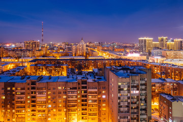 Fototapeta na wymiar Aerial view of night Voronezh downtown. Voronezh cityscape at blue hour. Urban lights, modern houses, television tower