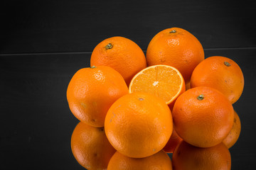 Orangen im Kreis halbe aufgeschnittene Orange  dunkler Hintergrund horizontal