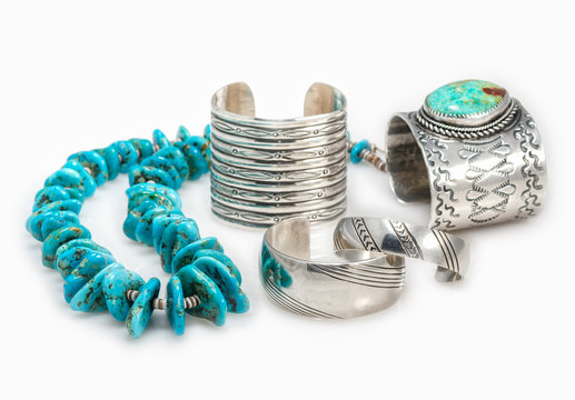 Collection of Sterling Silver Native American Bracelets with a Turquoise Nugget  Necklace with shallow depth of field.