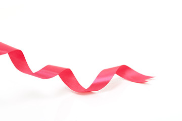 Pink curly ribbon on white