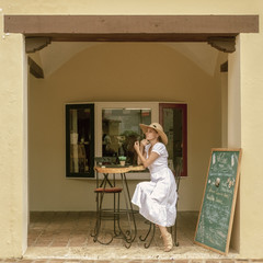 A girl on the veranda of a French cafe