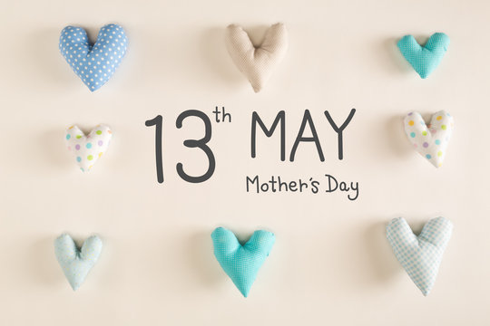 Mother's Day message with blue heart cushions on a white paper background
