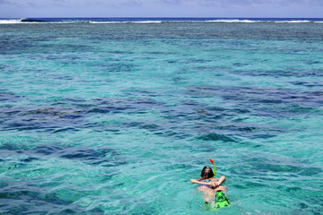 Woman snorkelling alone in Rarotonga Cook Islands