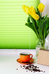 Yellow tulips and cup of coffee