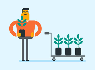 Young caucasian white gardener standing next to the wheelbarrow with plants in pots