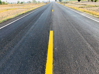 Obraz premium Highway road in the rice farm in Surin.