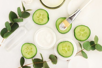 
Natural skincare with refreshing green cucumber slices. Jar of cooling moisturizer with brush,...