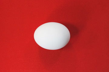 white chicken eggs on a red velvet background.