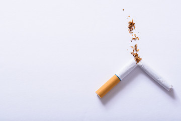 Broken cigarette on a white background with negative space. Quit  smoking