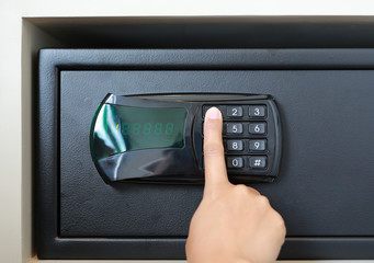 Female hand press key on safety lock Pad number. Secret Password Protection.