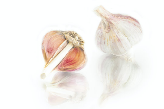 fresh nice garlic cloves and garlic bulb with reflection