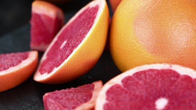 Portion of fresh Grapefruit rotating on a plate (seamless loopable; 4K)