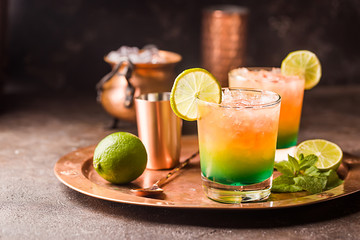 Orange cocktail decorated with lime