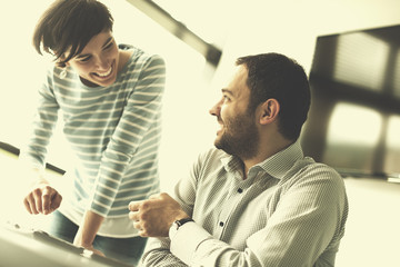 Two Business People Working With Tablet in startup office