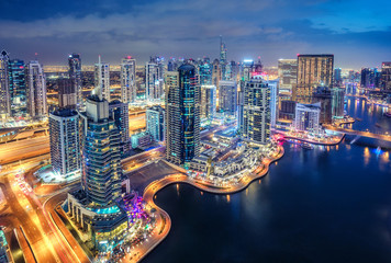Scenic aerial view of Dubai Marina by night. United Arab Emirates. Colourful travel background.