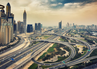 Fototapeta na wymiar Scenic panoramic view of modern city architecture. Aerial daytime skyline of Dubai Marina, UAE, with skyscrapers and highways. Summer travel background.