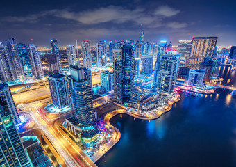 Fototapeta premium Scenic aerial view of Dubai Marina by night. United Arab Emirates. Colourful travel background.