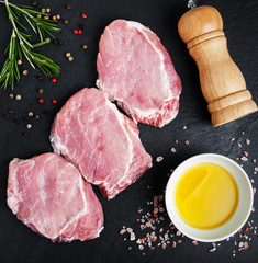 Fresh raw pork chops with spices and herbs