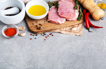 Fresh raw pork chops with spices and herbs