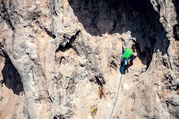 A man climbs the rock.