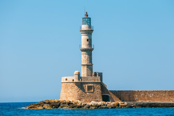 view of the entrance to Chania harbor with lighthouse, Crete, Greece