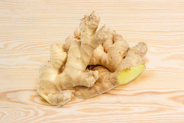 Two ginger roots on a wooden surface
