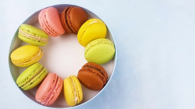 Sweet color macaroons or macaron in pastel blue gift box.