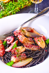 octopus with black spaghetti and garlic sauce