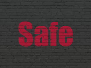 Protection concept: Painted red text Safe on Black Brick wall background
