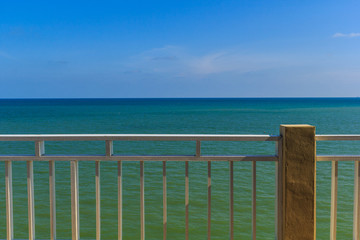 The beach has white fence