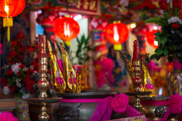 Red candles and burning incense sticks Paper gold for pay respect to god in Chinese New Year day at a Chinese shrine.